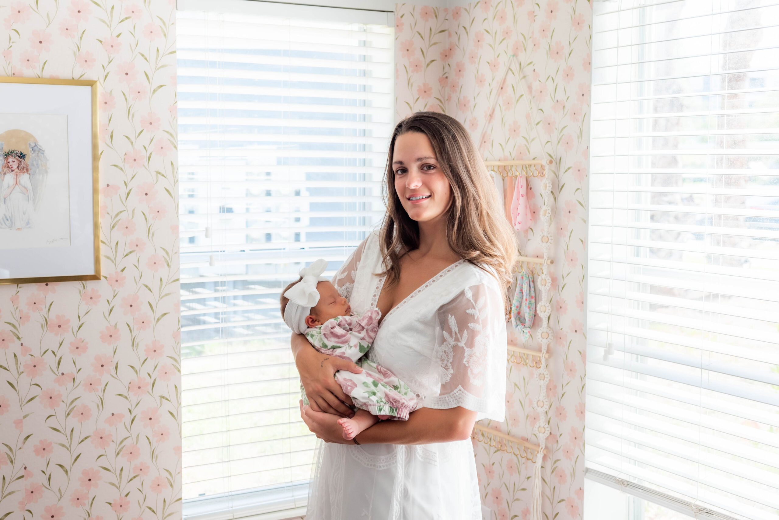 Mother holding newborn during lifestyle session in Tampa.