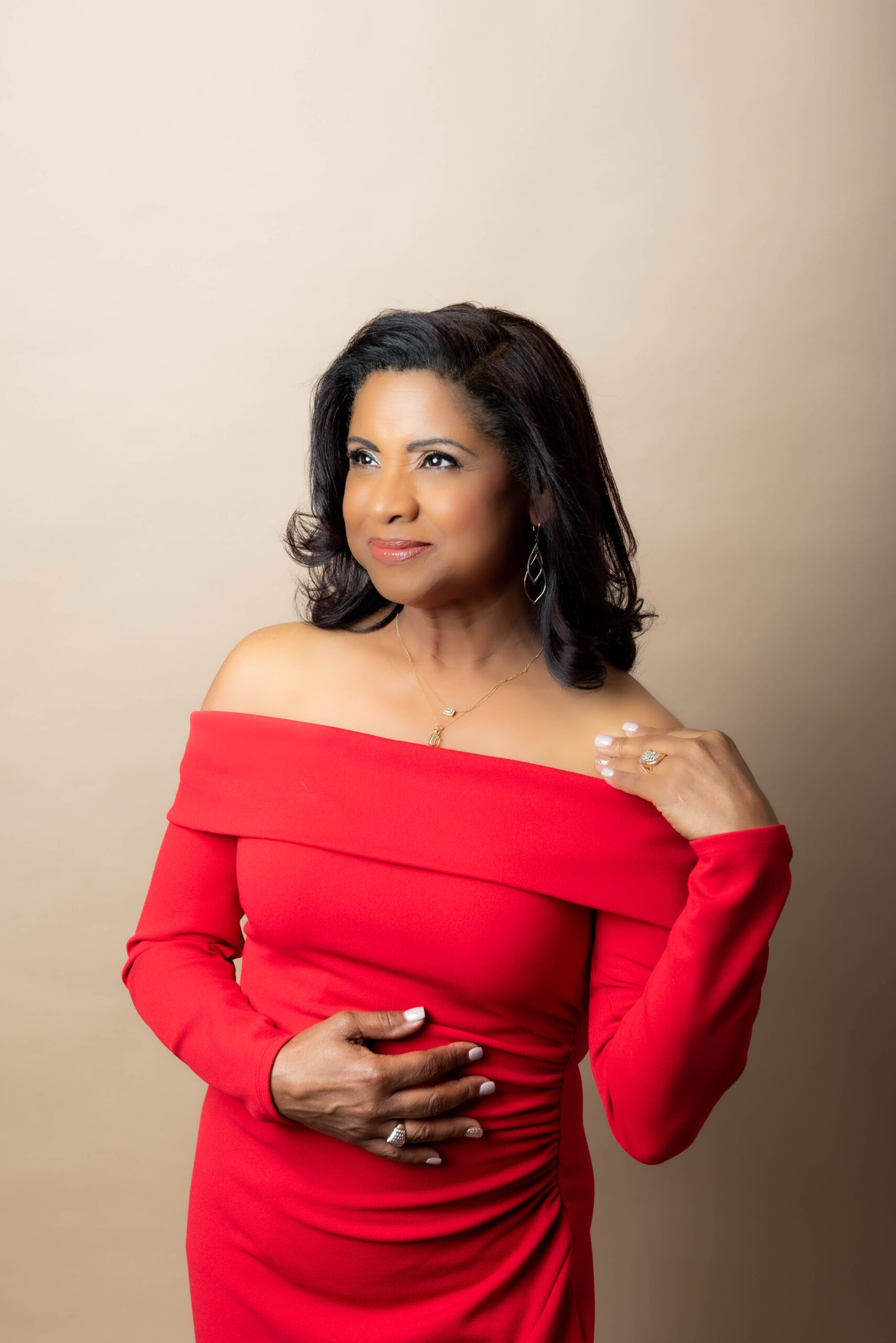 Woman in red dress in a studio portrait session.